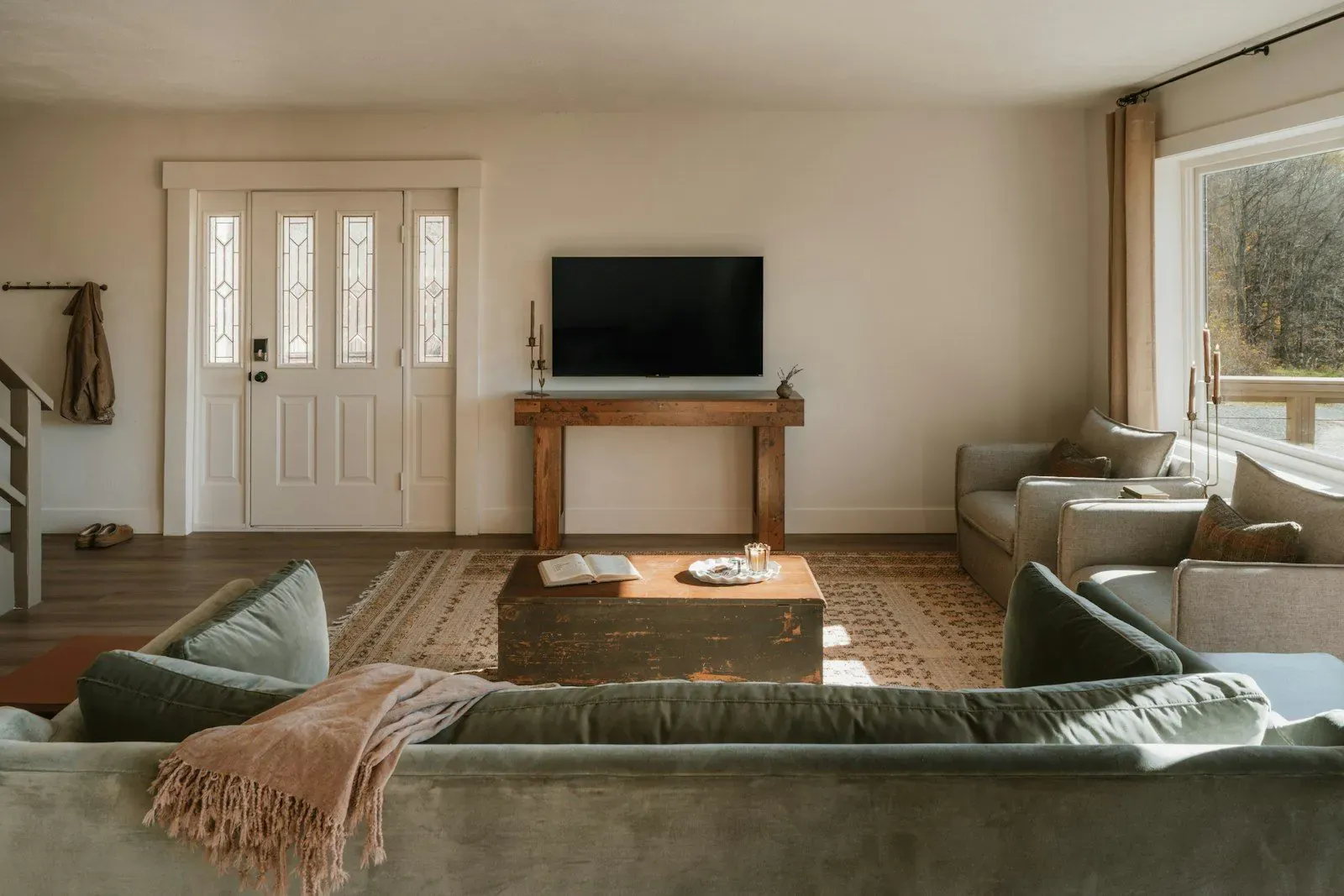 Cozy living room with sofas, warm lighting, and a television